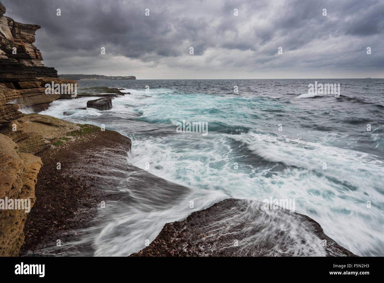 L'océan houleux à Sydney avec de gros nuages gris et unsert mer avec mousse blanche et couleur cyan Banque D'Images