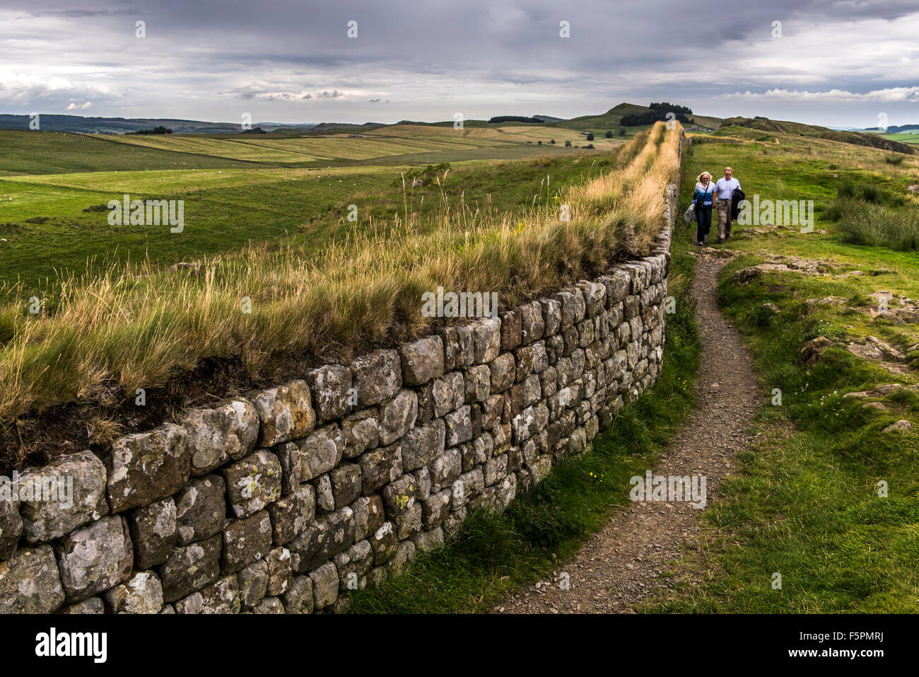 Mur d'Hadrien, avec couple en train de marcher aux côtés de Northumberland, Angleterre, Grande-Bretagne, Royaume-Uni Banque D'Images