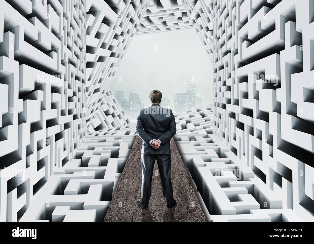 Businessman standing in abstract labyrinth Banque D'Images