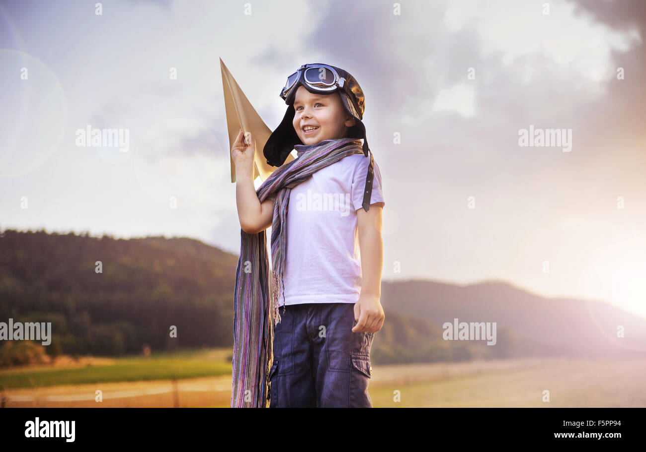 Jolie petite tenue pilote un avion en papier Banque D'Images