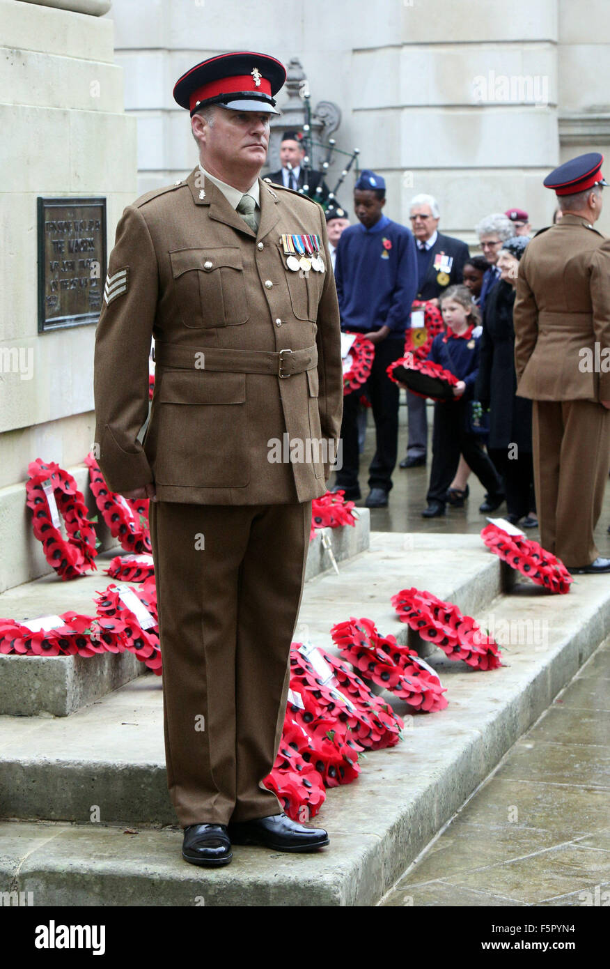 Portsmouth, Hampshire, Royaume-Uni. Nov 8, 2015. Portsmouth arrêté toujours en silence aujourd'hui pour marquer ceux qui sont tombés dans les guerres à travers le monde. Les foules se sont réunis à Guildhall Square pour rendre hommage à tous ceux qui ont servi dans les conflits à travers le monde. Des centaines de personnes se sont rendues à la place où la foule se tenait dans la réflexion sombre se souvenir de tous ceux qui se sont battus et sont morts pour leur pays. Des dirigeants communautaires, des représentants des forces armées, et des dirigeants de confiance tous les rejoint le service et déposé des couronnes pour ceux qui sont morts. Credit : UKNIPAlamy Live News Banque D'Images