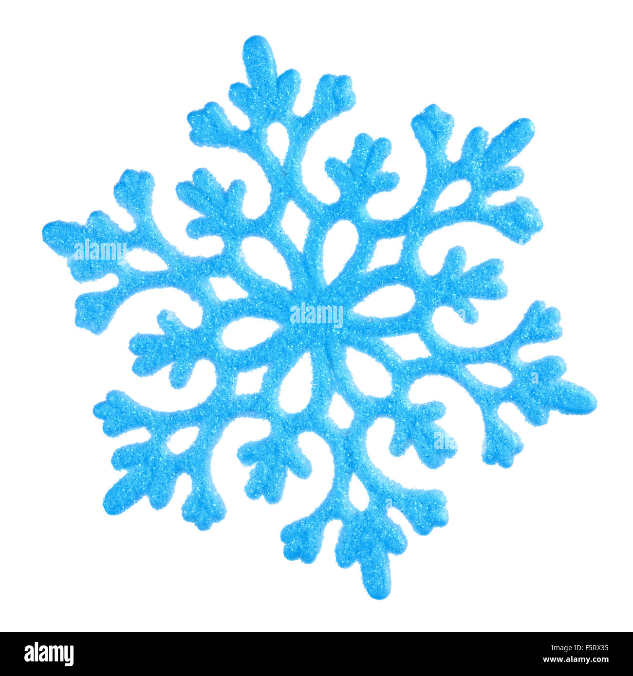 Studio close-up of a bright blue snowflake ornament on white background Banque D'Images