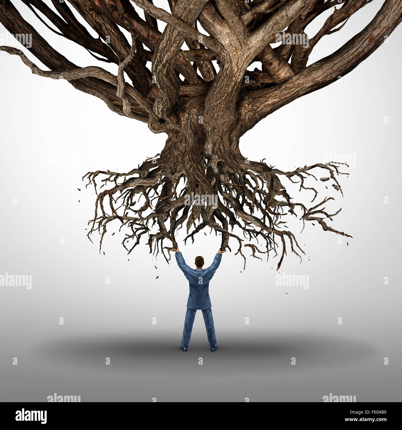Le déracinement et la croissance et concept mamnagement symbole comme businessman holding up d'un arbre déraciné par une icône pour les dommages causés à l'environnement comme une idée d'entreprise. Banque D'Images