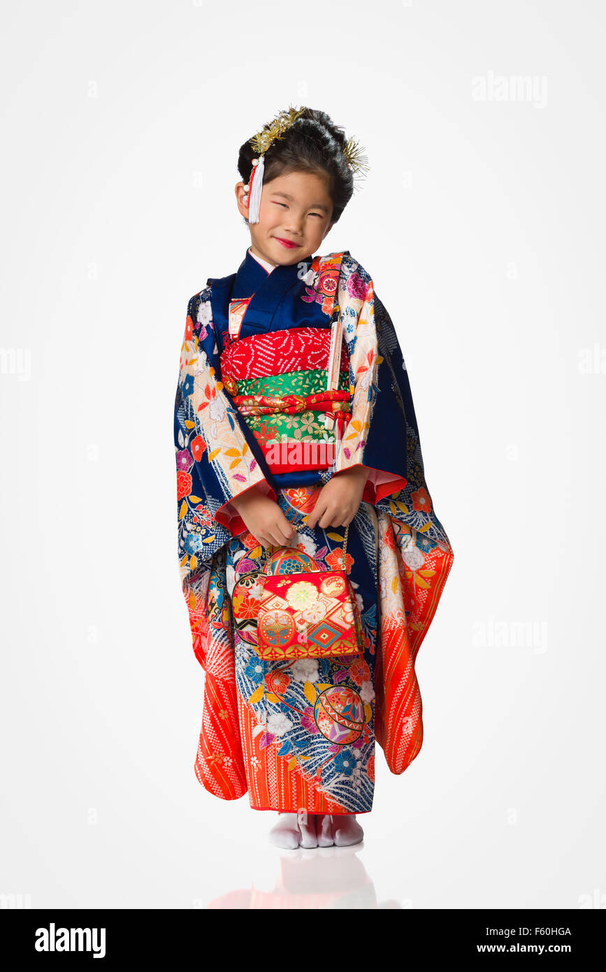 Une jeune fille portant un kimono japonais sur un fond blanc Photo Stock -  Alamy