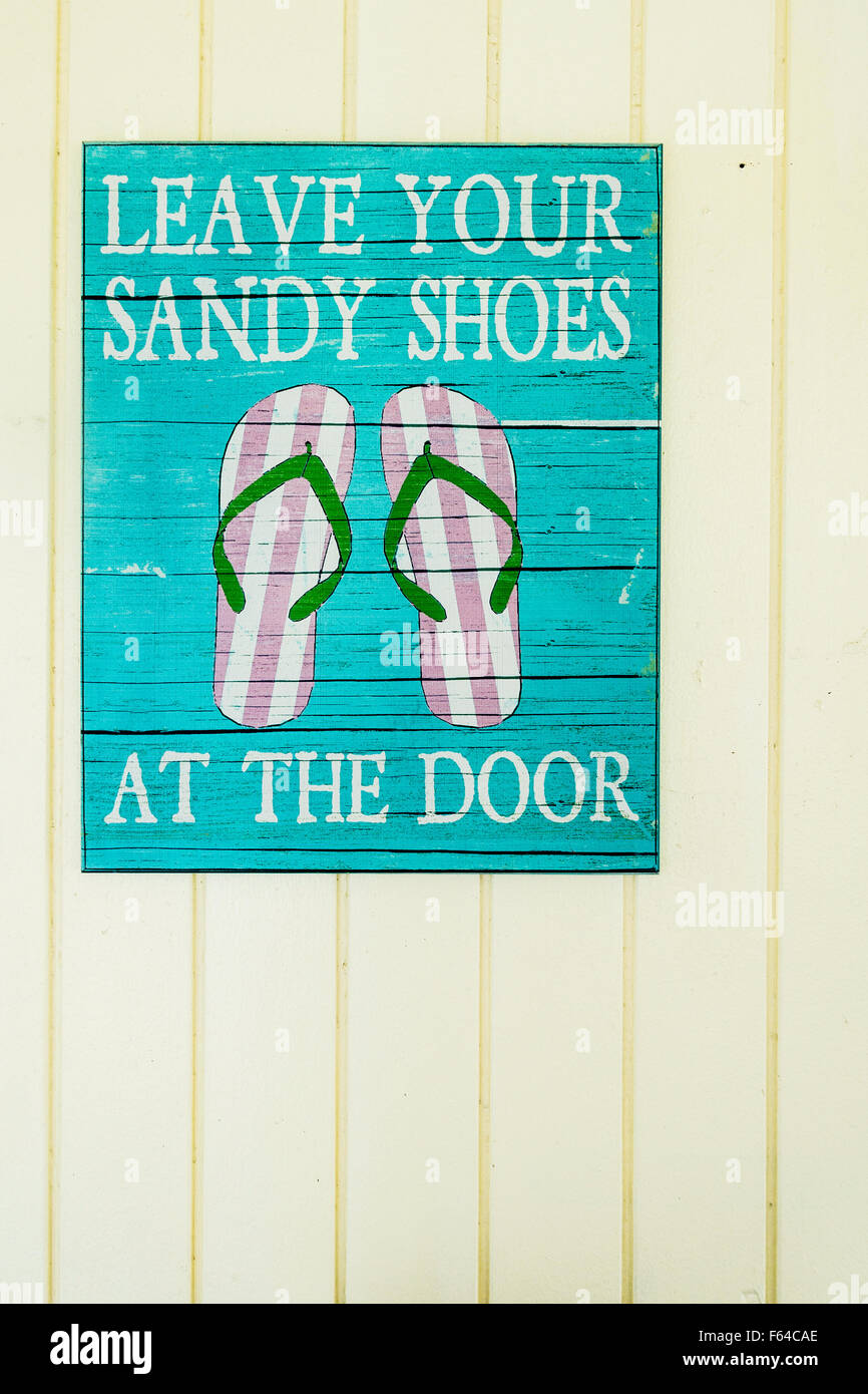 Un signe à un beachside resort demandant, "Laisser vos chaussures de sable à la porte.' Banque D'Images