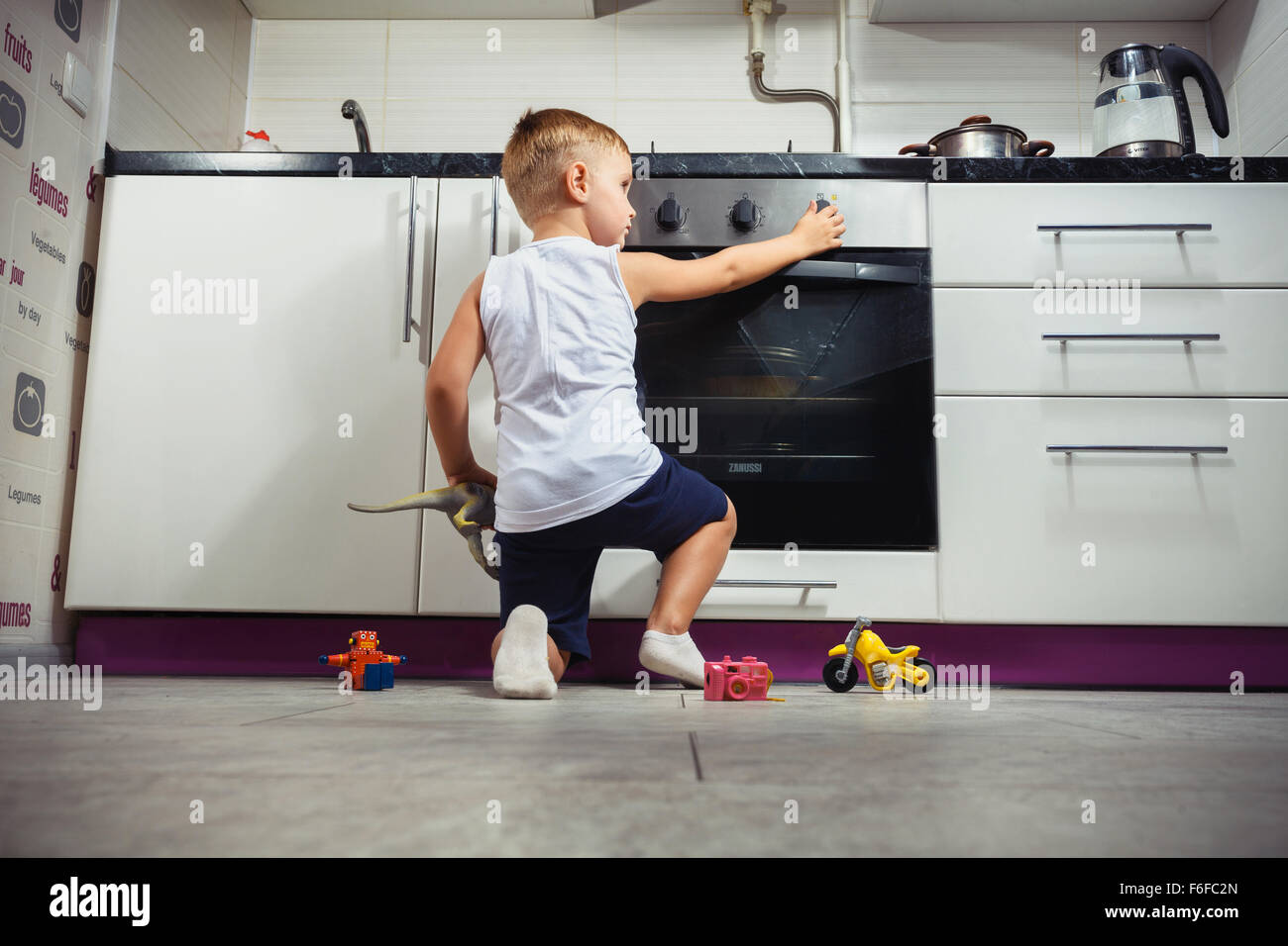 La prévention des accidents. L'enfant sans surveillance dans la cuisine avec une cuisinière à gaz. sans retoucher Banque D'Images