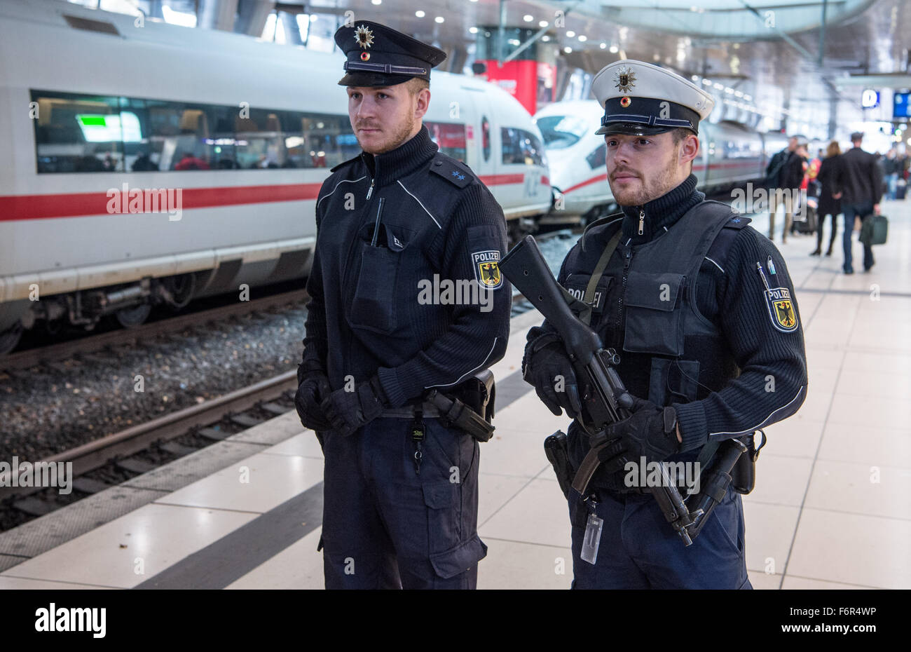 Francfort, Allemagne. 19 novembre, 2015. Deux officiers de la police fédérale avec une mitrailleuse se tenir sur une plate-forme et de regarder l'arrivée d'un train à grande vitesse dans la gare à l'aéroport de Frankfurt am Main, Allemagne, 19 novembre 2015. La police a arrêté et complètement évacué une glace ici en raison d'un panier casse-croûte suspectes. Rien n'a été trouvé. Photo : BORIS ROESSLER/dpa dpa : Crédit photo alliance/Alamy Live News Banque D'Images