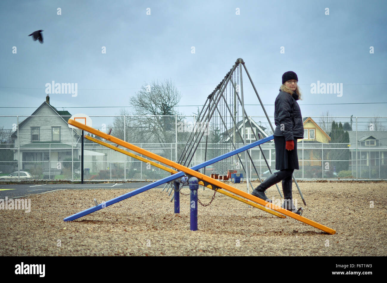Caucasian woman walking on playground seesaw Banque D'Images