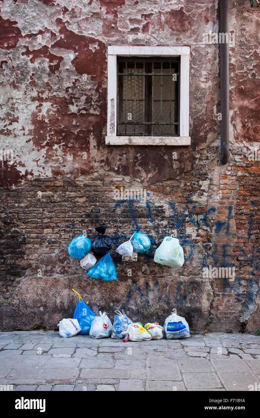 Venise Italie. Mur extérieur de maison détail de construction, fenêtre avec barres de cambrioleur et survécu à l'érosion, mur de briques endommagées de l'eau Banque D'Images