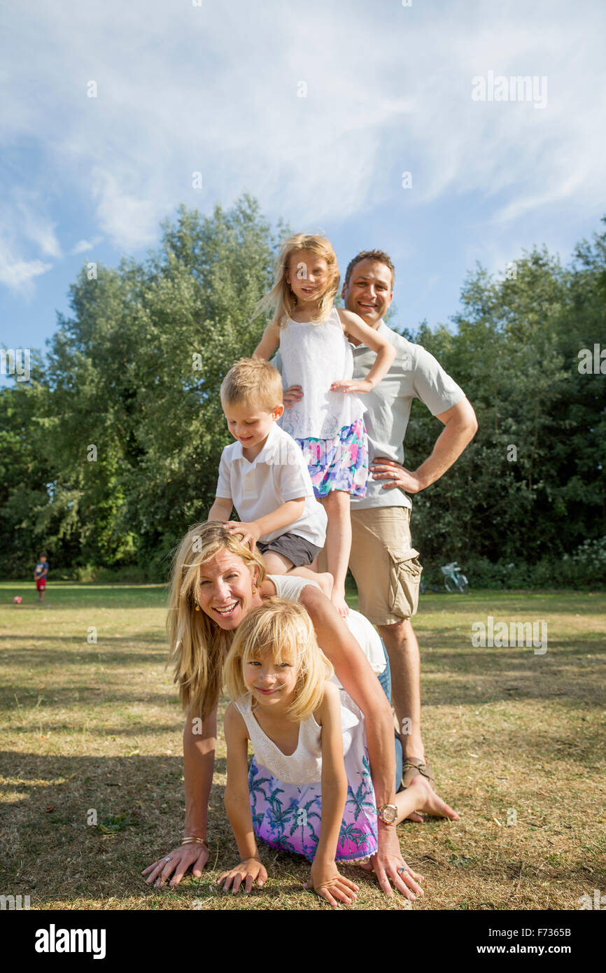 Famille avec trois enfants jouant dans un parc. Banque D'Images