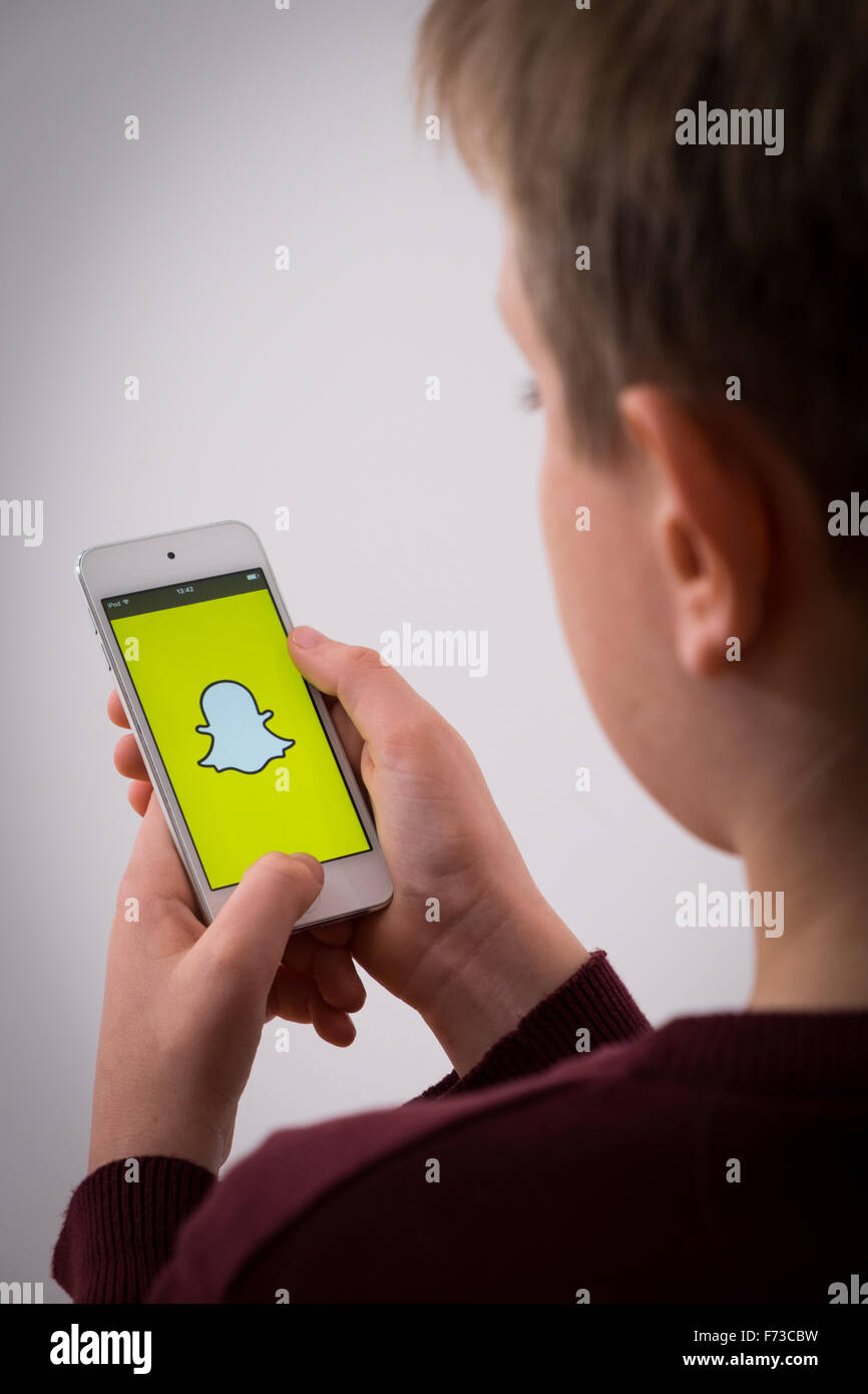 Un garçon en utilisant l'application Snapchat Banque D'Images