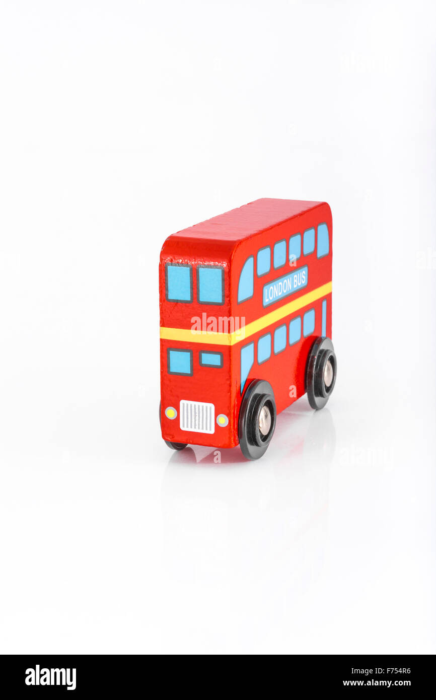 Jouet en bois London bus rouge sur fond blanc - pour London Transport et Transport for London (TFL). Métaphore pour se déplacer et travailler à Londres. Banque D'Images