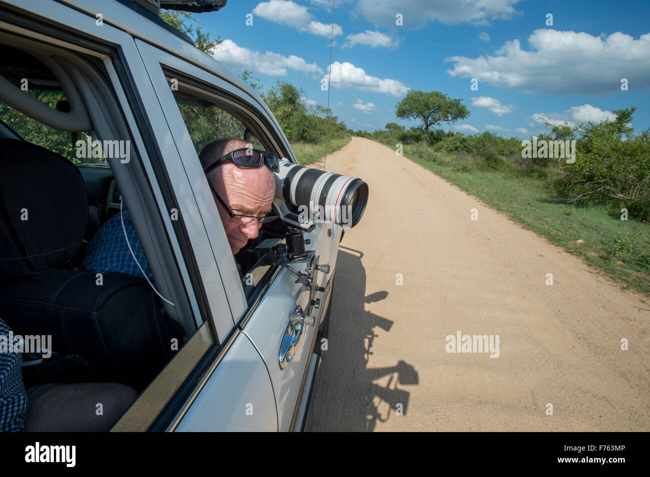 Photographe en voiture avec téléobjectif fixé à la porte du Parc National Kruger en Afrique du Sud Banque D'Images