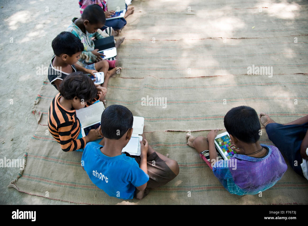 Enfants étudiant sur un ordinateur tablette, Banaras, Benaras, Varanasi, Uttar Pradesh, Inde, Asie Banque D'Images