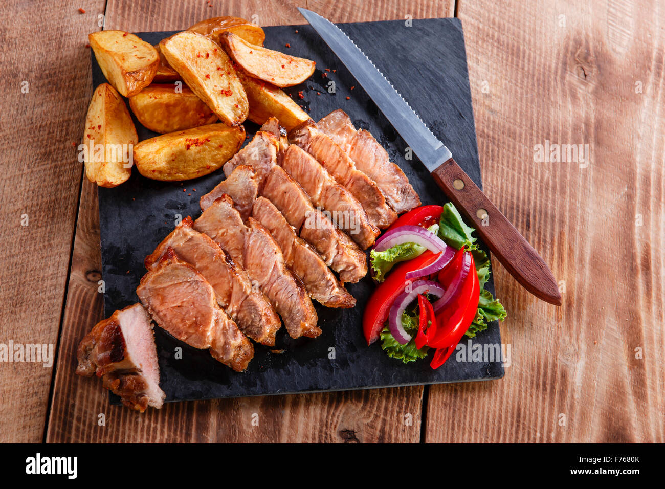 Tranches de steak de porc avec des pommes de terre sautées Banque D'Images