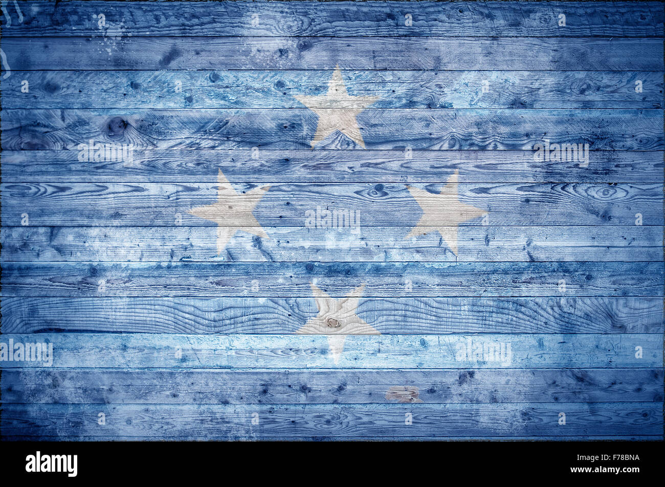 Une vignetted image de fond du drapeau de Micronésie peints sur des planches de bois d'un mur ou le plancher. Banque D'Images