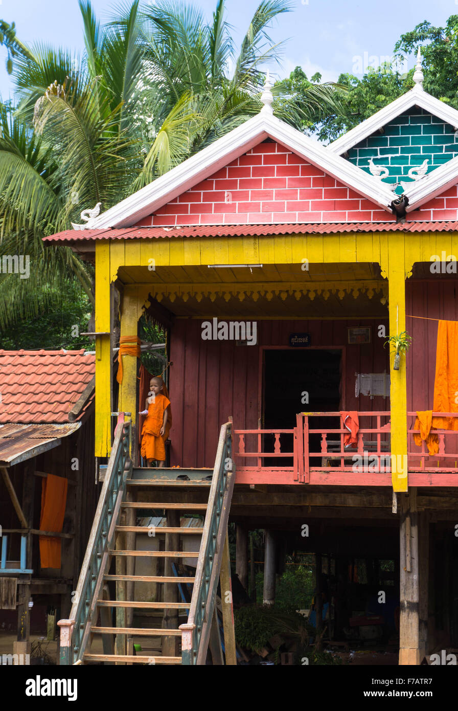 Wat Hanchey, Cambodge : un jeune moine novice dans une maison sur pilotis traditionnelle dans un village cambodgien Banque D'Images