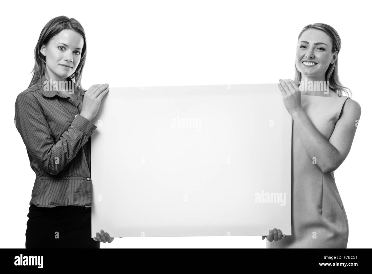 Deux business woman holding up un conseil Banque D'Images