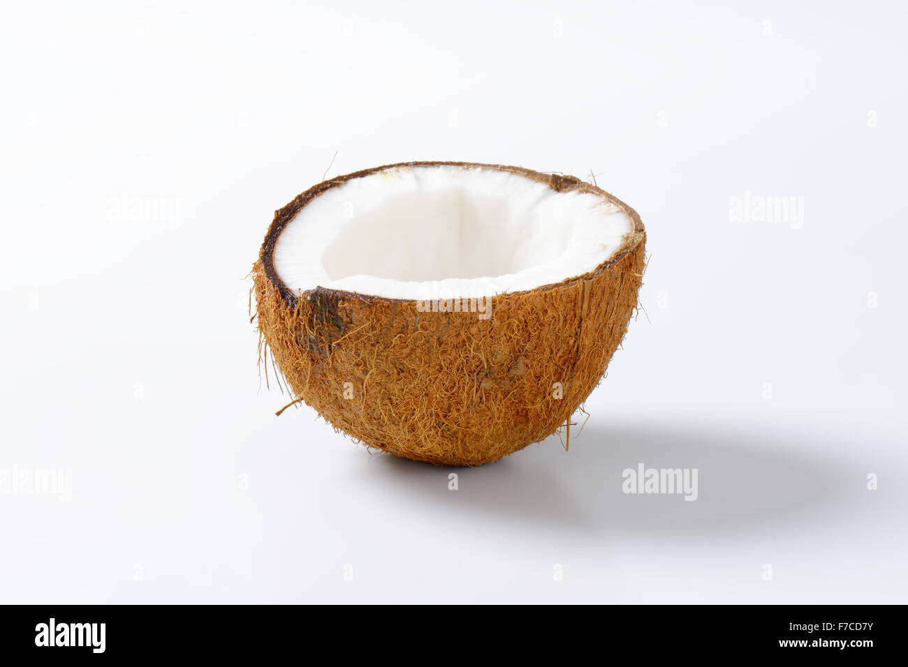 La moitié d'une noix de coco sur fond blanc Banque D'Images