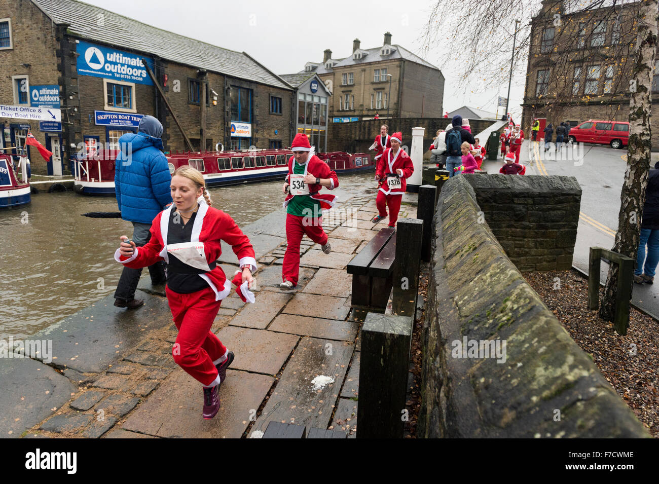 La course annuelle du père pour la charité à travers la ville de Skipton, Yorkshire. Le terme prend en Aireville Park, du centre-ville et le Leeds - chemin de halage du canal de Liverpool. Cette année, les coureurs ont bravé la pluie et vents forts pour terminer le cours. Banque D'Images