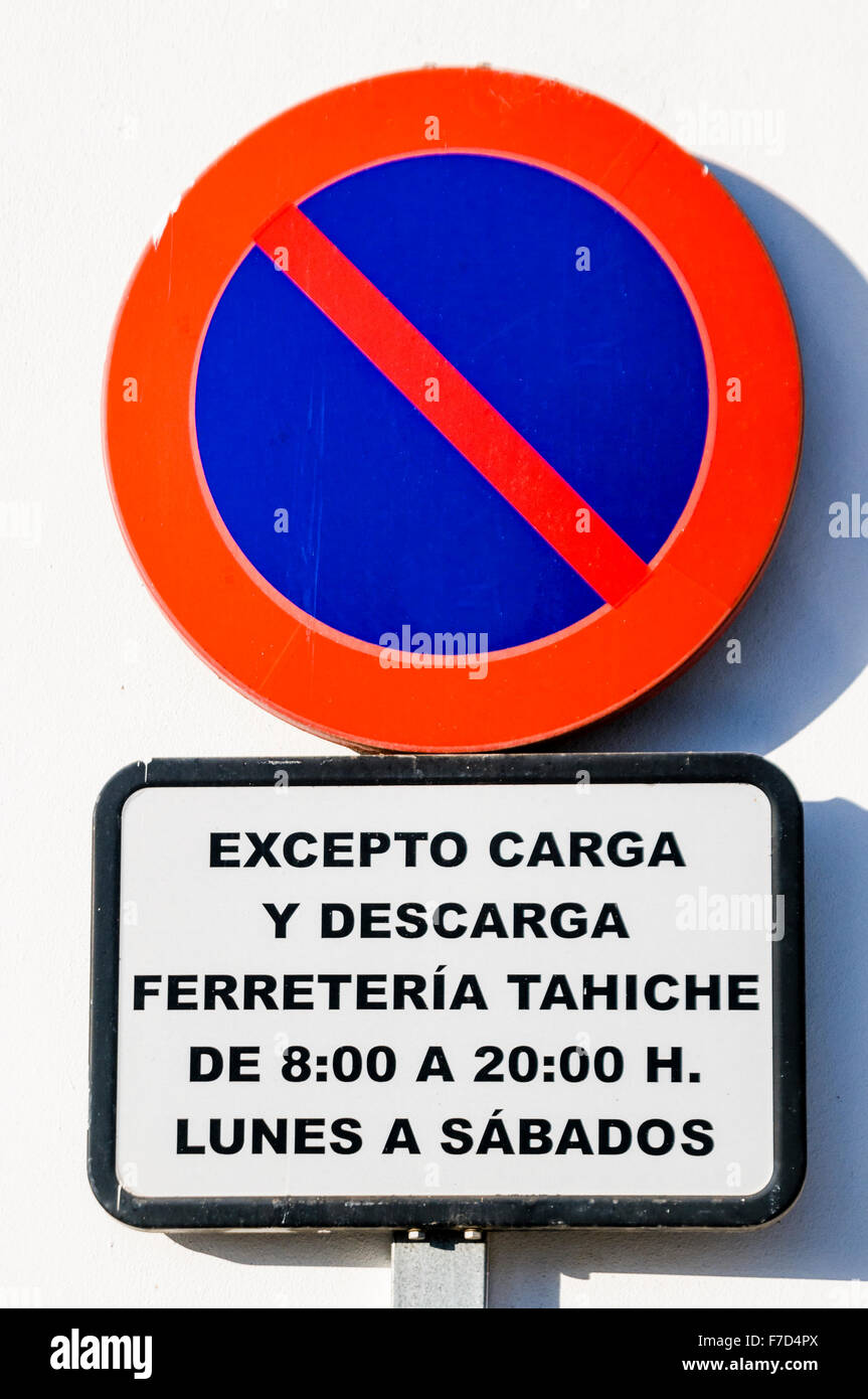 Panneau de circulation dans une ville espagnole aux automobilistes d'avertissement de ne pas stationner, à l'exception du chargement et déchargement pendant certaines périodes Banque D'Images