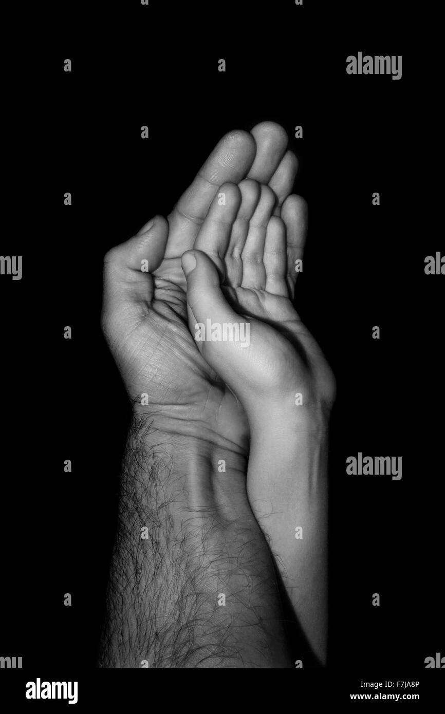 Le père et l'enfant / Photographie de père et enfant mains pressées ensemble Banque D'Images