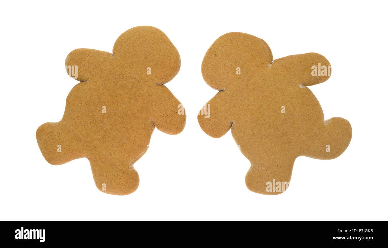 Deux hommes unfrosted gingerbread cookies de Noël côte à côte en biais sur un fond blanc. Banque D'Images