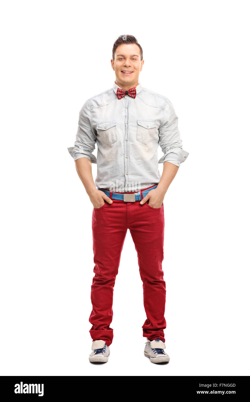Portrait d'un jeune homme élégant posant en jeans rouge isolé sur fond blanc Banque D'Images