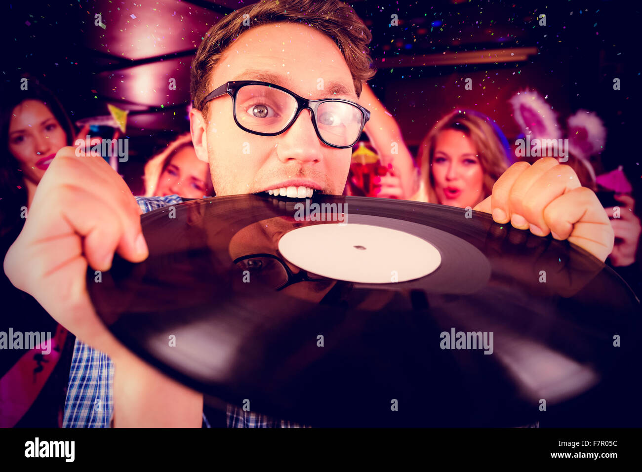 Image composite de hipster geek biting vinyl record Banque D'Images