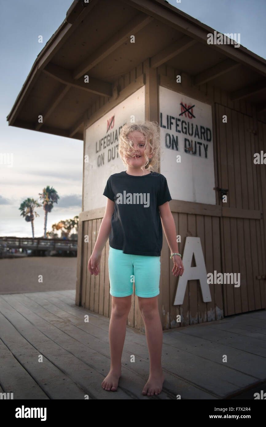 Girl standing in front of a lifeguard station Banque D'Images