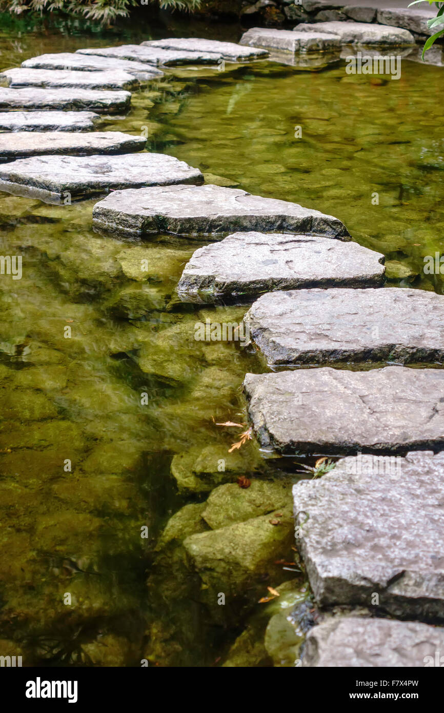 Stepping Stones dans un étang dans le jardin japonais Banque D'Images