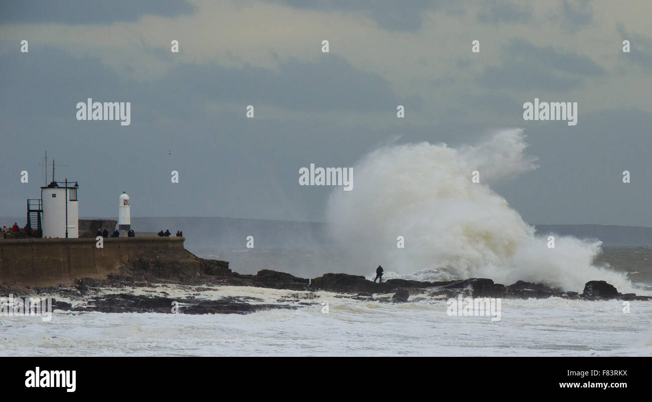 Porthcawl, Pays de Galles, Royaume-Uni, 5 décembre 2015. Un photographe se met en danger pour capturer les énormes vagues battant la côte sud du Pays de Galles. Crédit : Tom Guy/Alamy Live News Banque D'Images