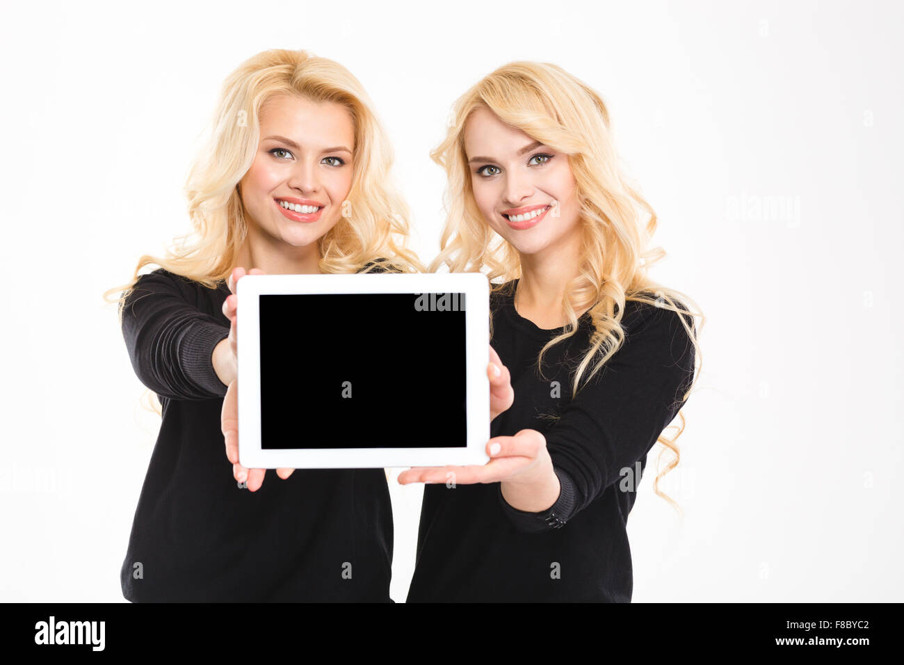 Deux Jeunes Sœurs Mignon Belle Blonde Jumeaux Montrant L Ecran De L Ordinateur Tablette Blanche Sur Fond Blanc Photo Stock Alamy