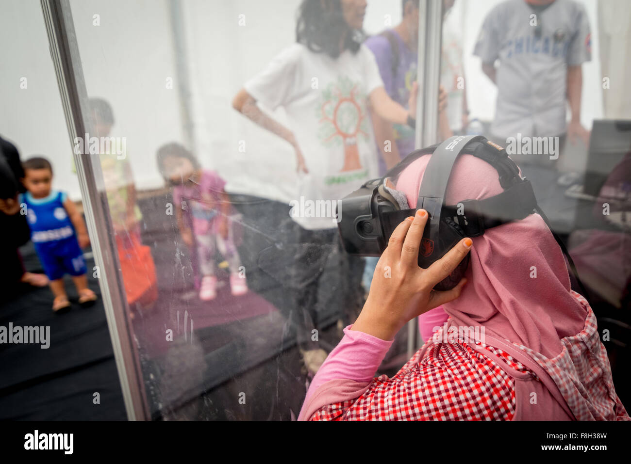 Visiteur regardant un écran de réalité virtuelle sur la biodiversité des forêts tropicales et les impacts des feux de forêt, lors d'un événement public organisé par Greenpeace. Banque D'Images