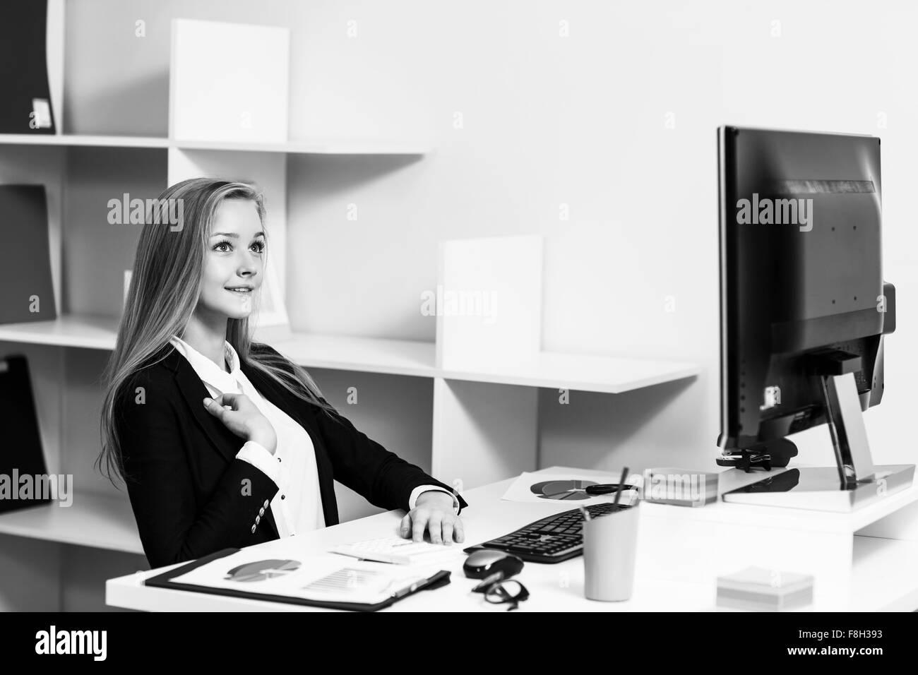 Femme assise au bureau avec ordinateur Banque D'Images