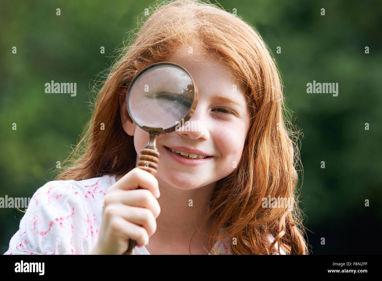 Girl Looking through Loupe avec Akihma Banque D'Images