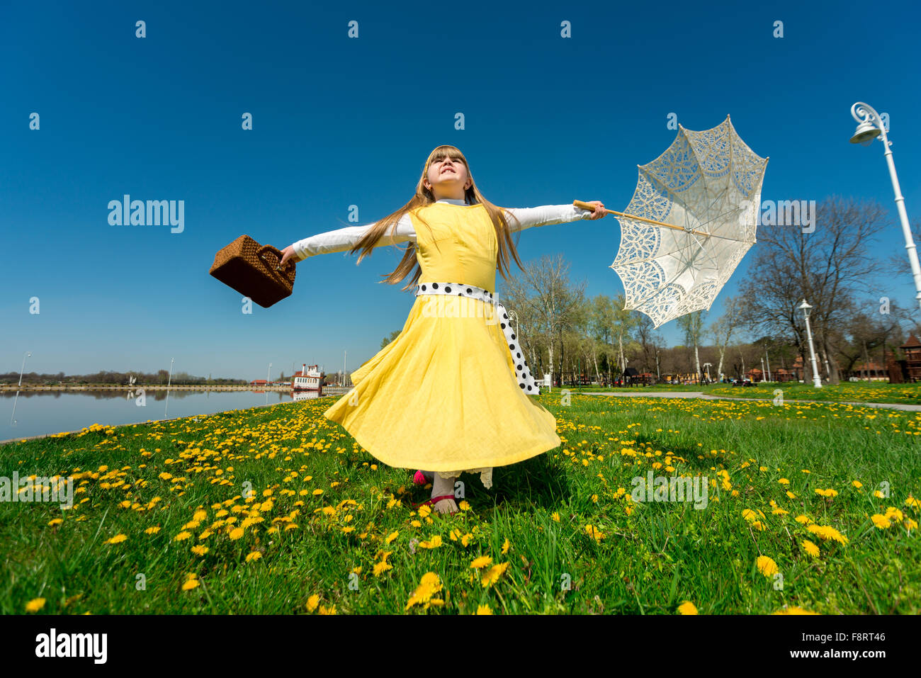 Petite fille jouant dans la nature, jouissant de la liberté tout en tournant sur son axe Banque D'Images