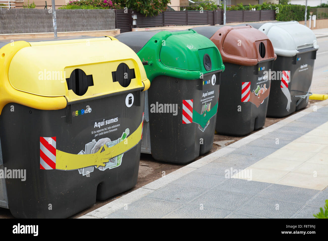 Calafell, Espagne - 22 août 2014 : les contenants de plastique colorés dans une ligne pour séparer la collecte des déchets Banque D'Images