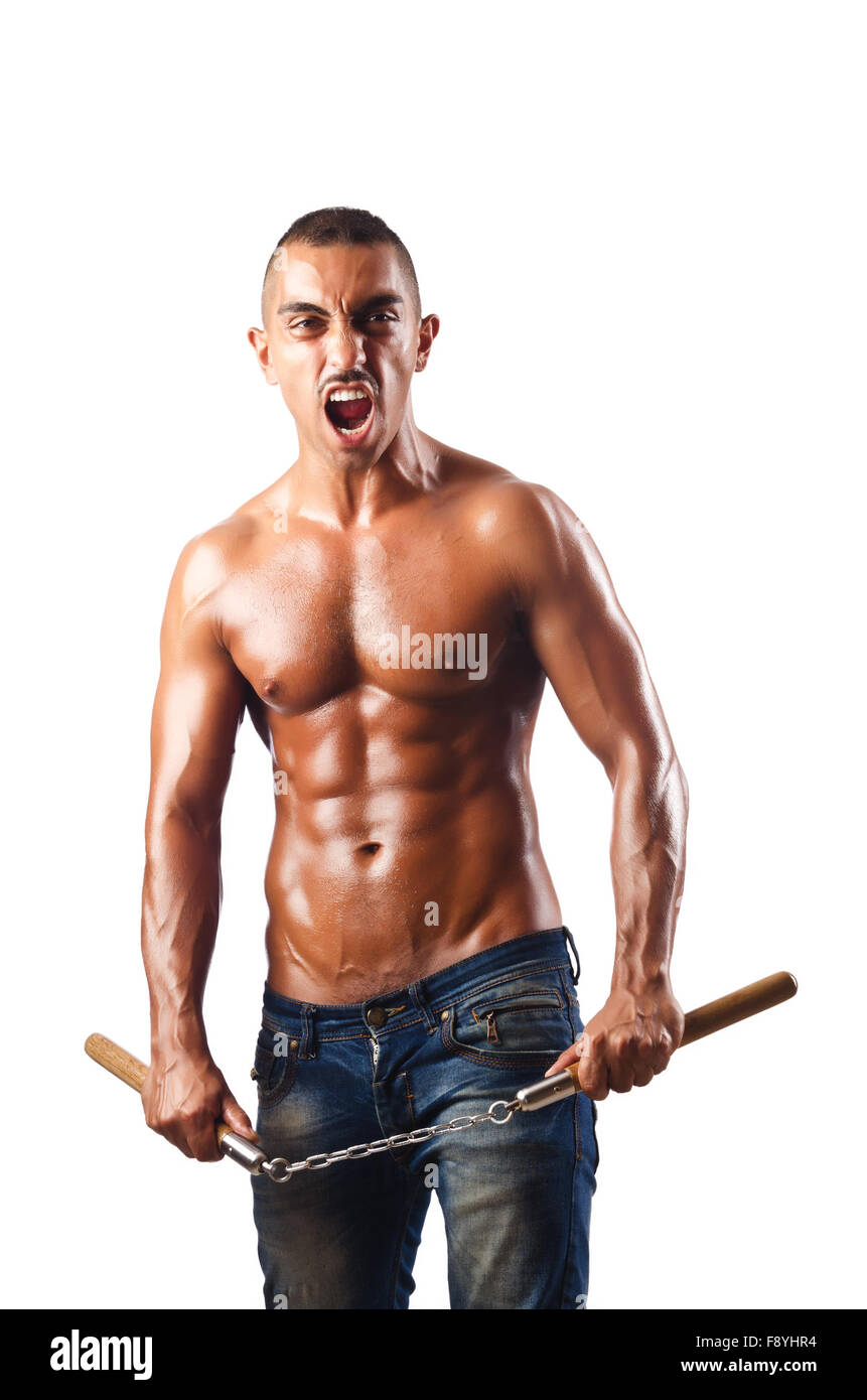L'homme dans les arts martiaux concept avec nunchucks Banque D'Images