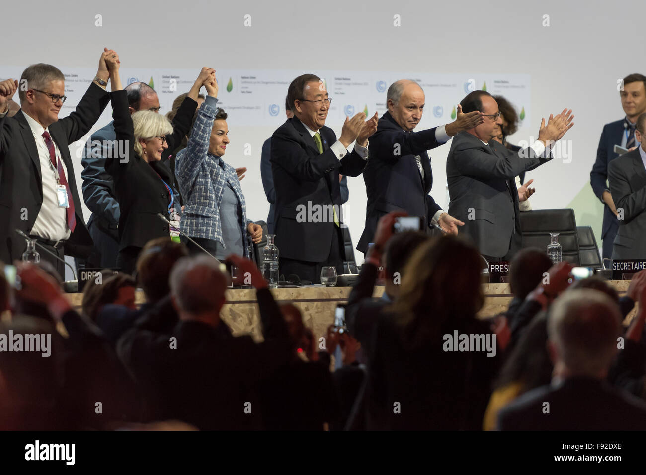 Paris, France. Dec 12, 2015. Le ministre des Affaires étrangères, et le président désigné de la CDP21, Laurent Fabius (2-R), les applaudissements avec le Secrétaire général de l'Organisation des Nations Unies, Ban Ki Moon (3-R) et le président français François Hollande (R) après l'adoption d'un pacte historique le réchauffement lors de la COP21 sur le climat, tenue à Paris. © Jonathan Raa/Pacific Press/Alamy Live News Banque D'Images