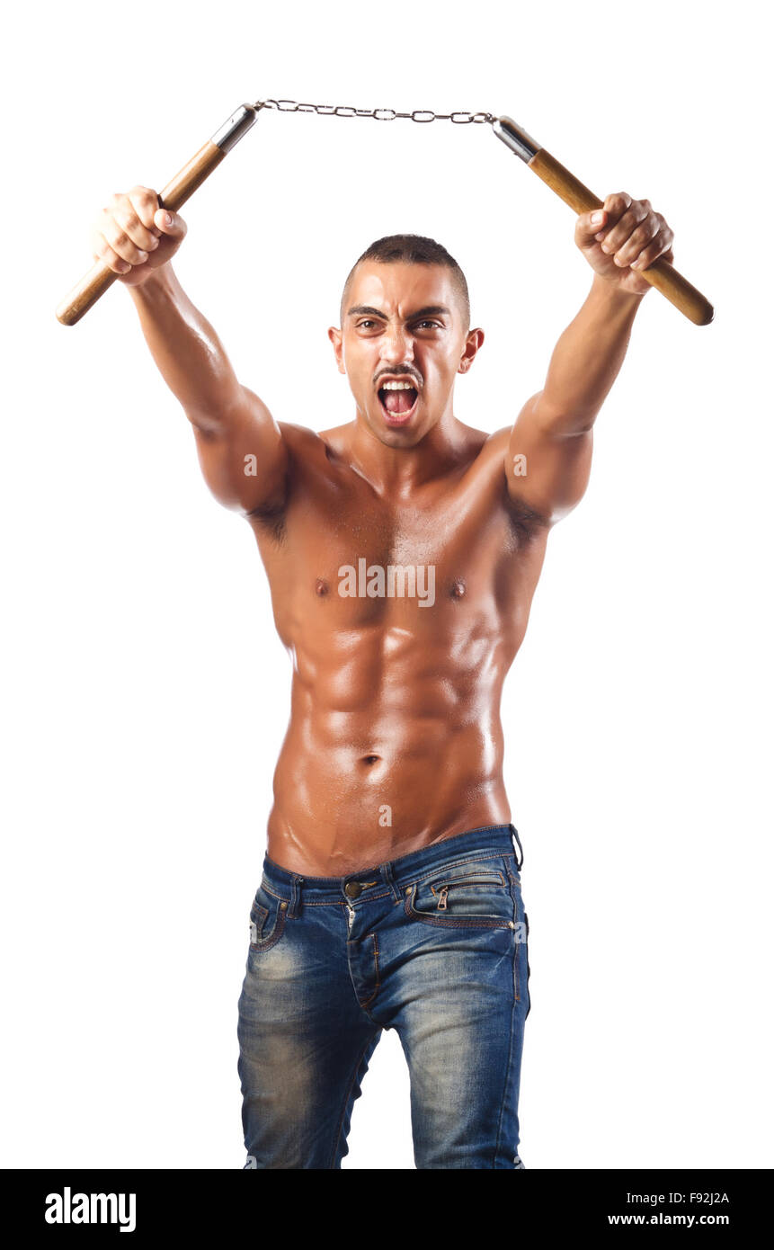 L'homme dans les arts martiaux concept avec nunchucks Banque D'Images
