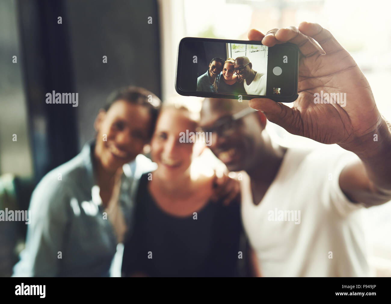 Amis de prendre un multi ethnic avec un téléphone selfies Banque D'Images