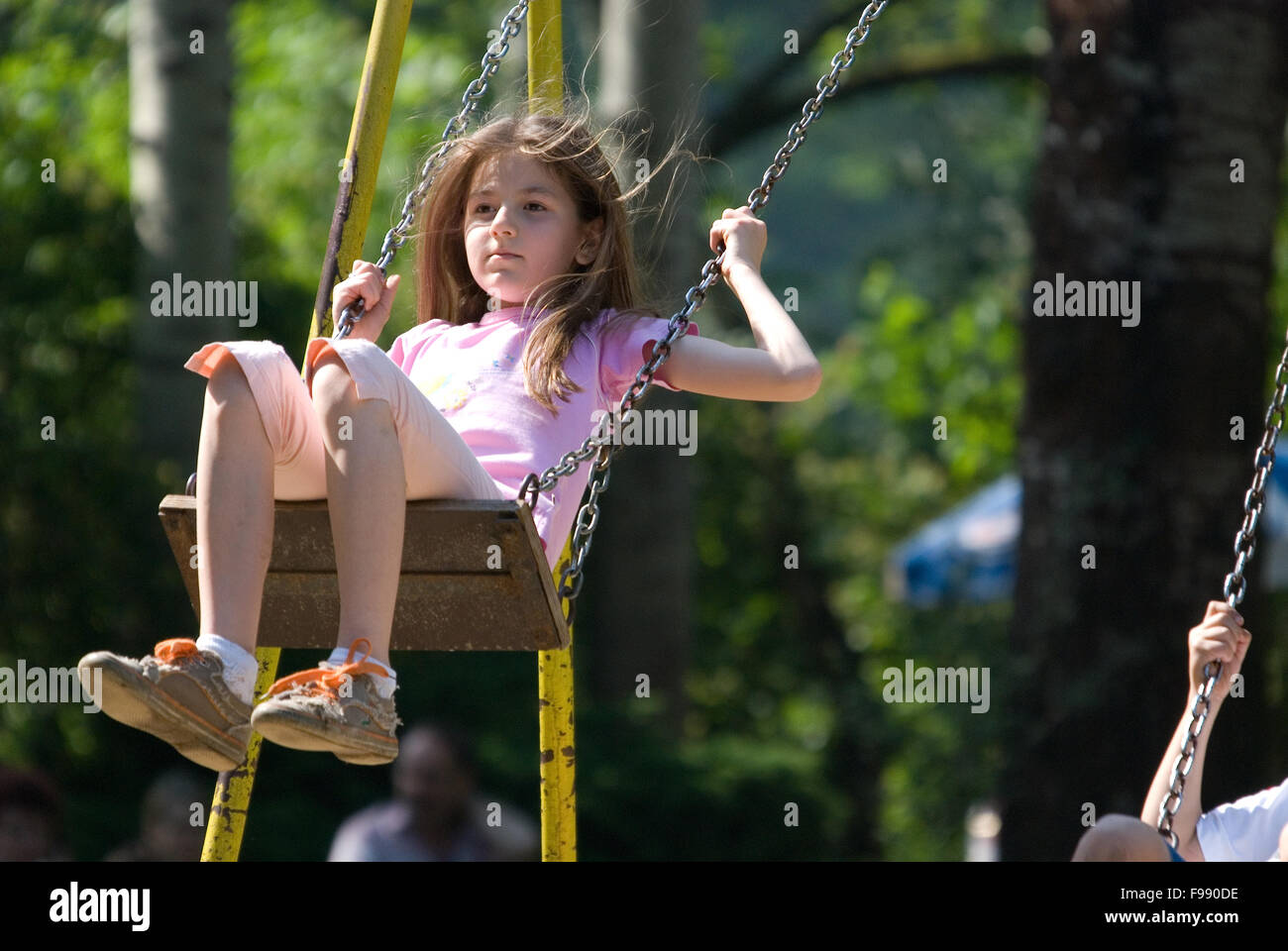 Happy girl swinging (Nikon D80 ; 10.6.2007, 1/640 à f/6.3 ; ISO 500 ; balance des blancs : auto ; longueur focale : 320 mm) Banque D'Images