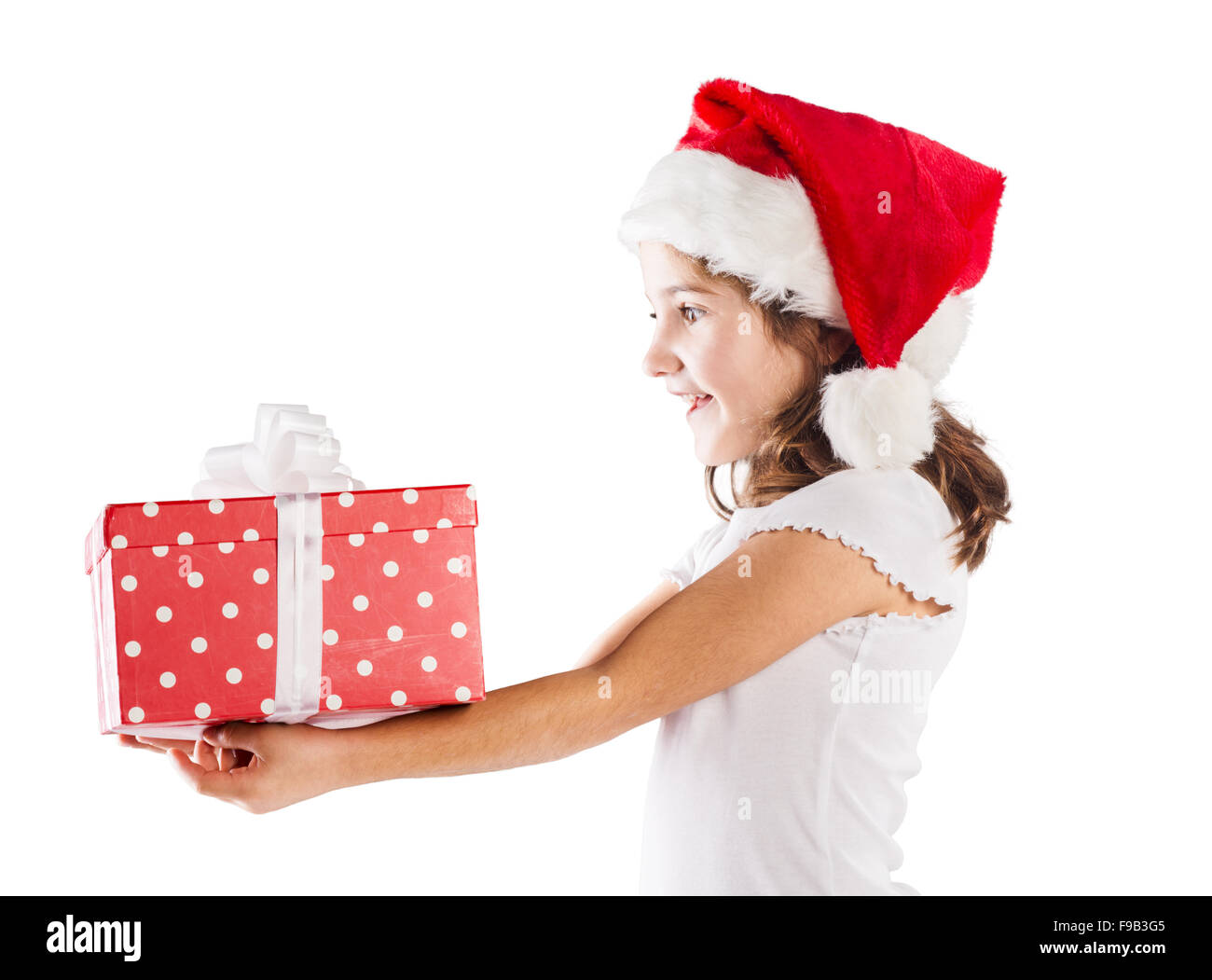 Petite fille heureuse à santa hat with christmas gift Banque D'Images