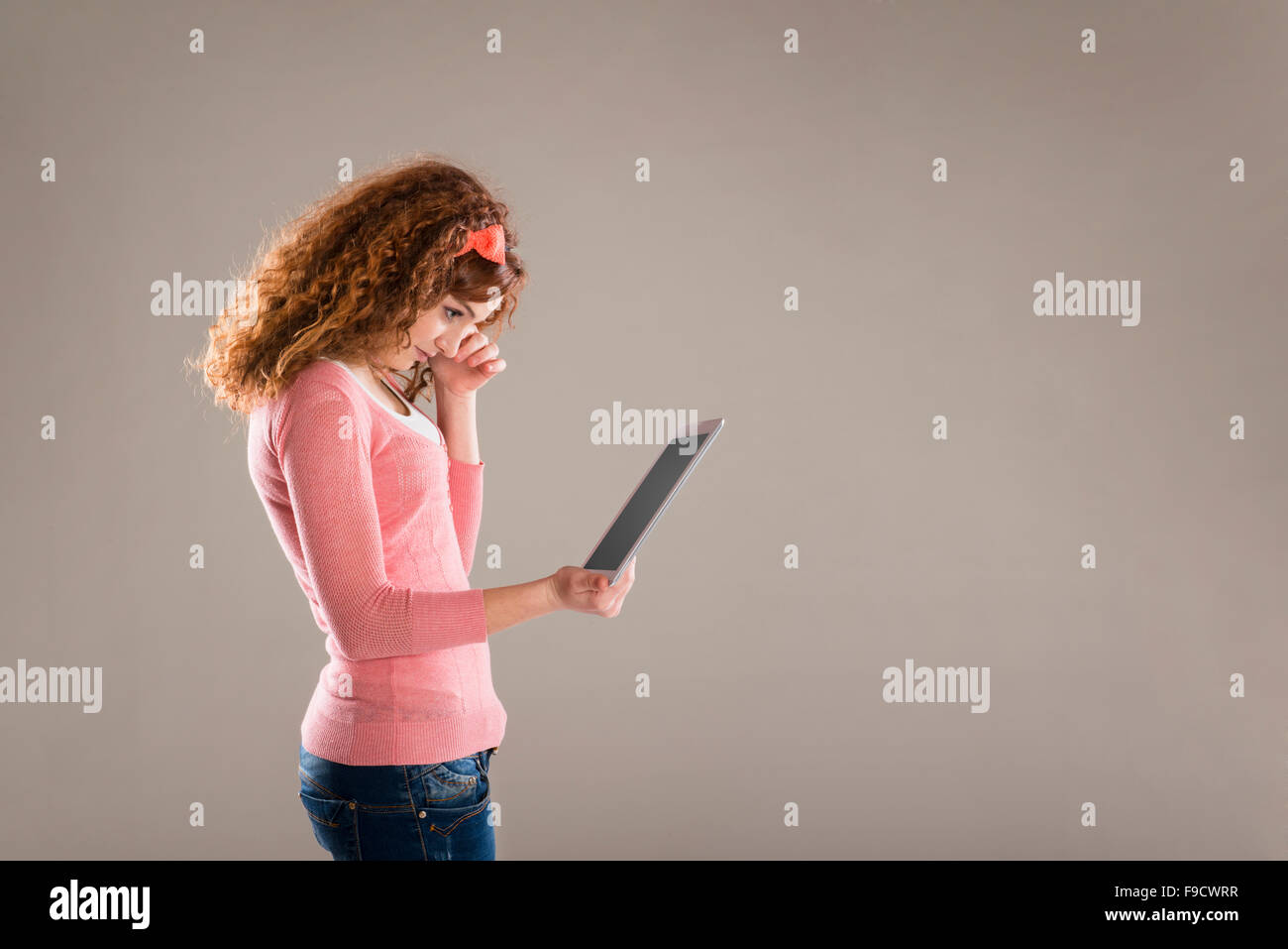 Belle jeune fille avec tablette en studio Banque D'Images