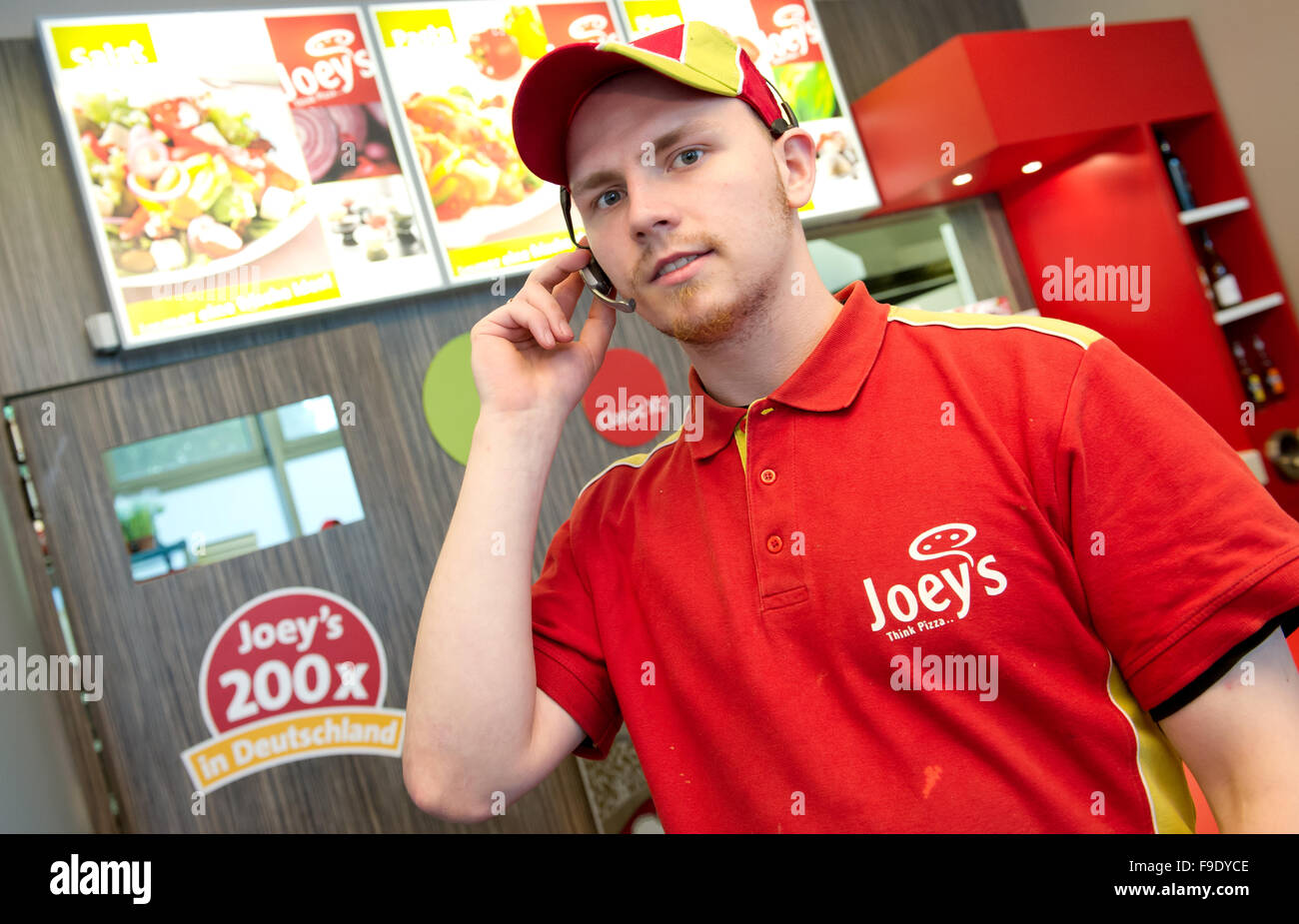 Hambourg, Allemagne. 24 mai, 2013. Un employé de Joey's Pizza livraison prend un téléphone à une franchise à Hambourg, Allemagne, 24 mai 2013. À l'heure actuelle, la société, fondée en 1988, compte 130 franchisés dans toute l'Allemagne. Photo : SVEN HOPPE/dpa/Alamy Live News Banque D'Images