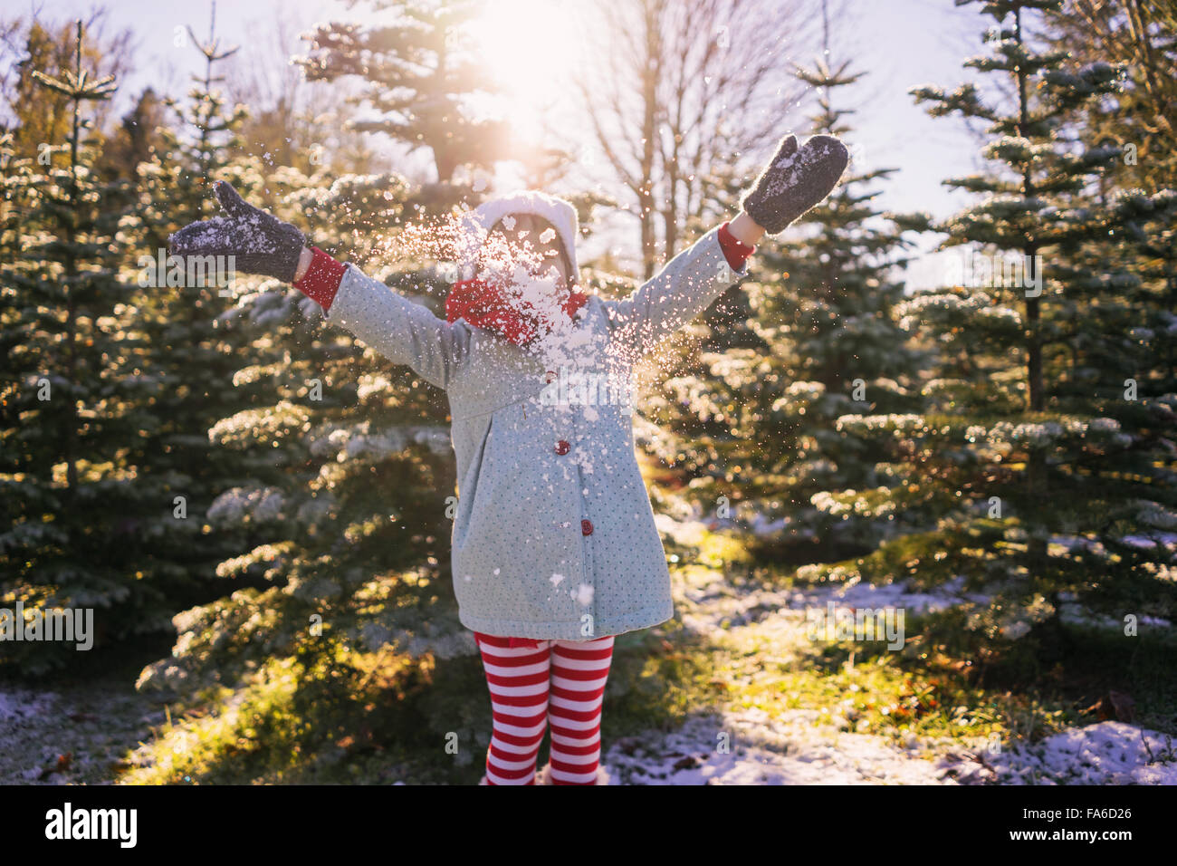 Girl throwing snow dans l'air Banque D'Images