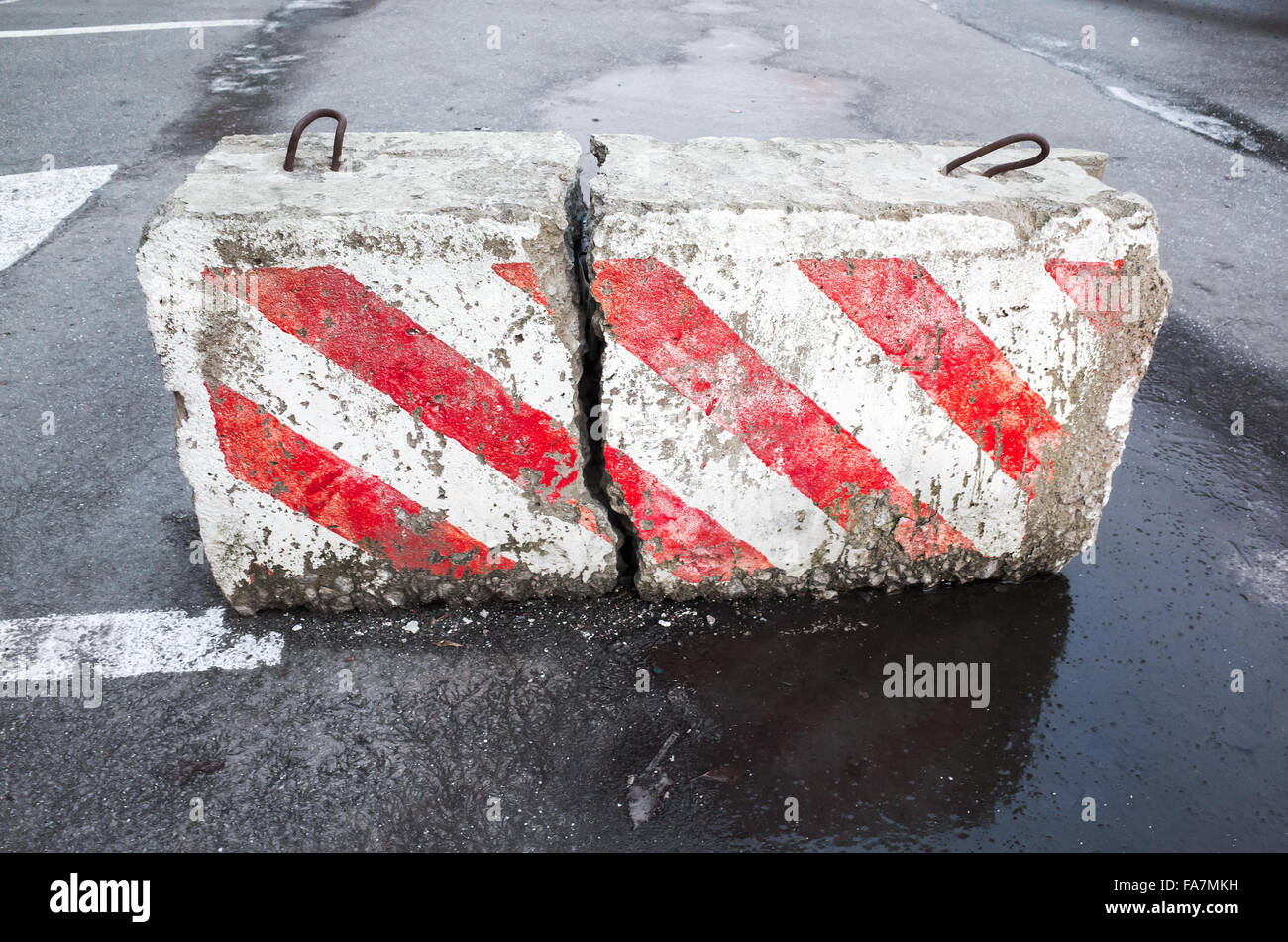 Bloc de béton blanc et rouge d'avertissement avec motif à rayures en diagonale Banque D'Images