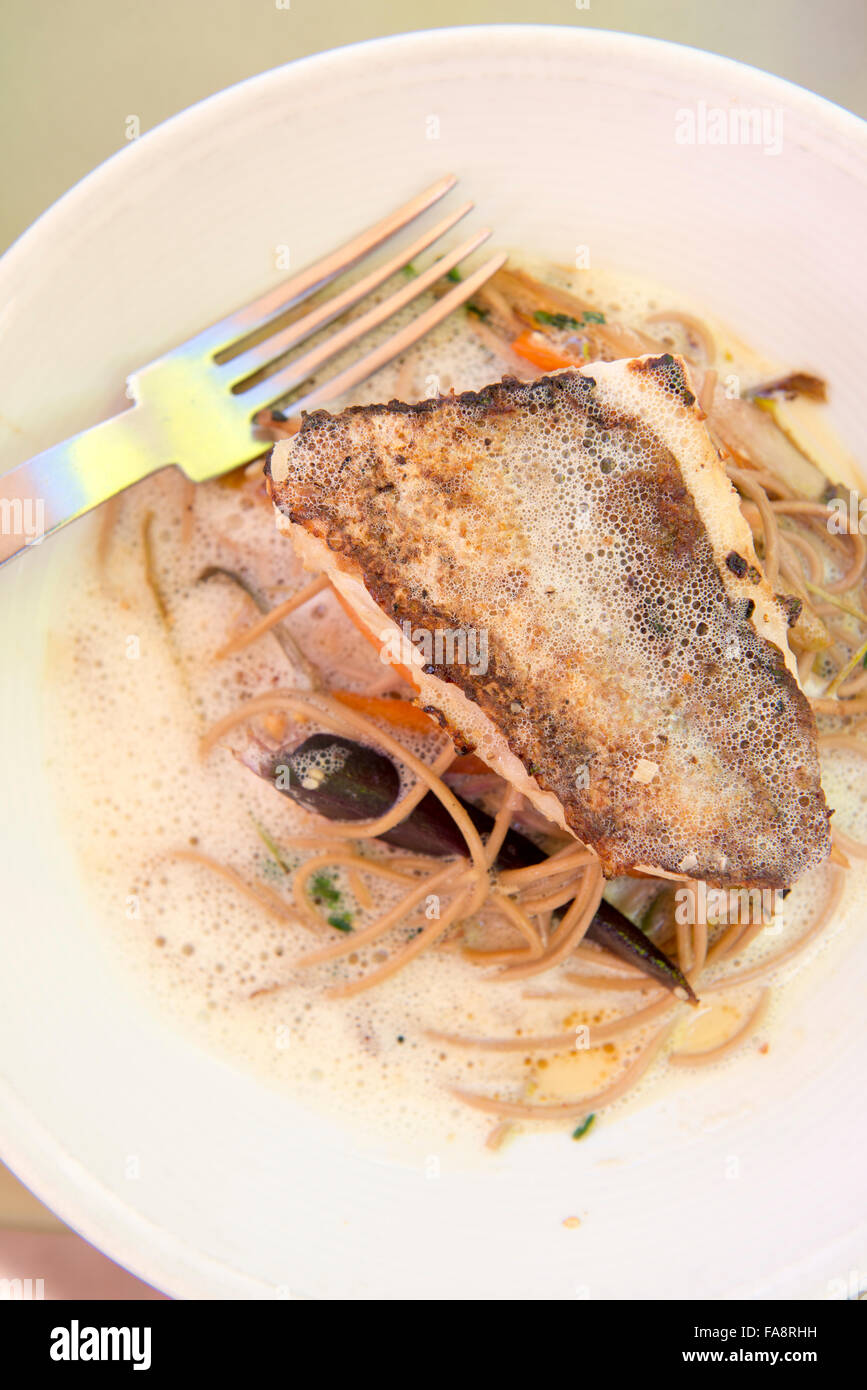 Un plat de poisson sur un lit de nouilles soba au Café des Epices, un restaurant situé dans le quartier du Panier de Marseille. Banque D'Images