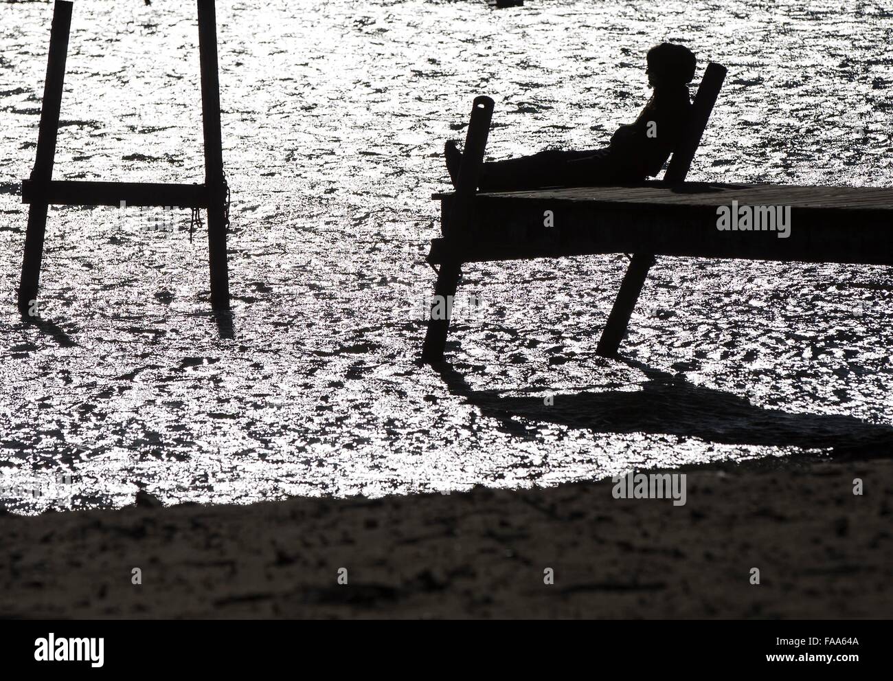 Toronto, Canada. Le 24 décembre, 2015. Une femme assise sur une terrasse bénéficie du soleil à Toronto, Canada, le 24 décembre 2015. Toronto's a atteint 15 degrés Celsius et le jeudi est devenu la veille de Noël le plus chaud jamais enregistré. La température moyenne historique pour le 24 décembre à Toronto est minous un degré Celsius. Credit : Zou Zheng/Xinhua/Alamy Live News Banque D'Images